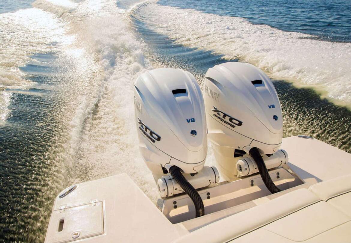 White Yamaha XTO Offshore V8 Motor on back of boat on water